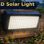 100 LED solar motion sensor light mounted on a garden fence at dusk, switched on